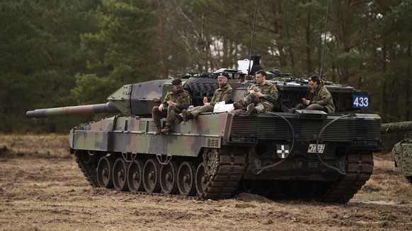 A crew of the Leopard 2 A7V main battle tank from Bundeswehr training battalion 93, pauses during an exercise at the training area in Munster, Germany, Wednesday, March 16, 2022. (Philipp Schulze/dpa  ...