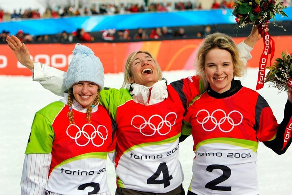 Swiss Tanja Frieden, centre, celebrates after winning the Womens Snowboard Cross, with second US American Lindsey Jacobellis, left, and third Canadian Dominique Maltais, right, at the Turin 2006 Winte ...