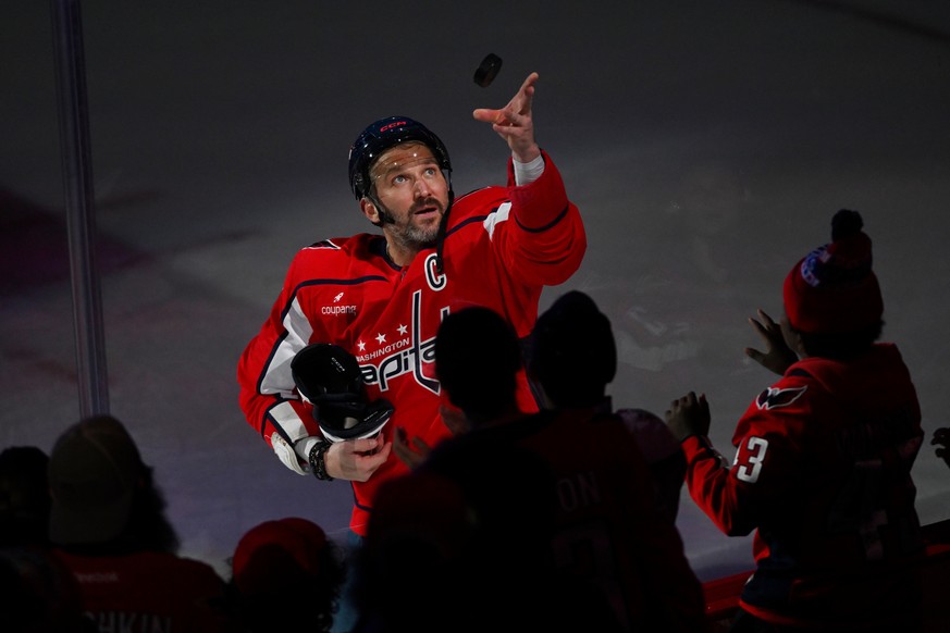 Washington Capitals left wing Alex Ovechkin (8) tosses a puck to fans after the end of an NHL hockey game against the St. Louis Blues, Wednesday, Nov. 5, 2025, in Washington. (AP Photo/John McDonnell) ...
