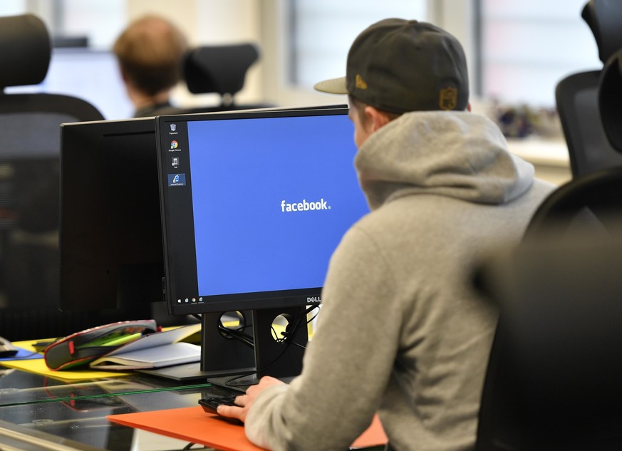 FILE �?? In this Nov. 23, 2017, file photo, employees of the Competence Call Center (CCC) work for the Facebook Community Operations Team in Essen, Germany. About 500 people control and delete faceboo ...