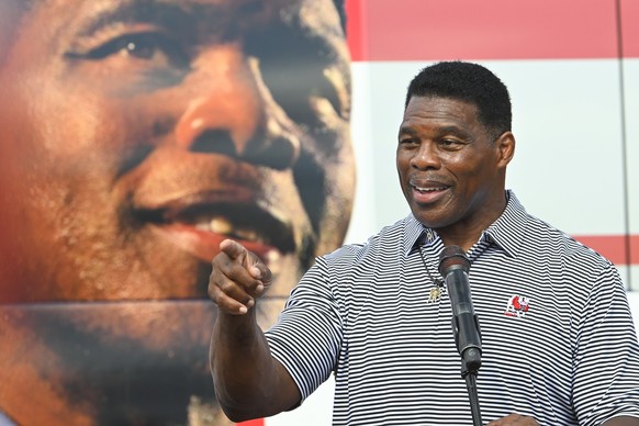 epa10291363 Herschel Walker campaigns for Senate in front of his bus which bears a larger than life image of himself during an event in Hiram, Georgia, USA, 06 November 2022. The US midterm elections  ...