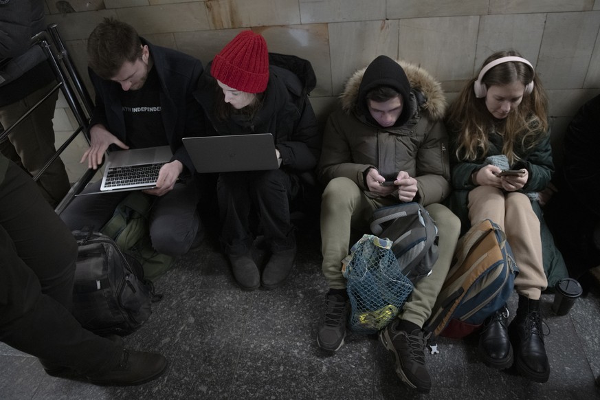 People rest in the subway station being used as a bomb shelter during a rocket attack in Kyiv, Ukraine, Monday, Dec. 5, 2022. Ukraine���s air force said it shot down more than 60 of about 70 missiles  ...