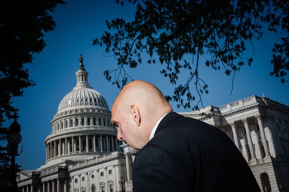 WASHINGTON, DC - APRIL 18: Sen. John Fetterman (D-PA) walks to a news conference on the &quot;Ending Trading and Holdings in Congressional Stocks (ETHICS) Act&quot; and efforts to ban members of Congr ...