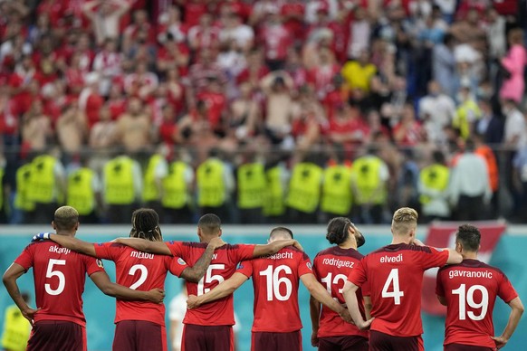Switzerland players stand facing their supporters during a penalty shootout at the end of the Euro 2020 soccer championship quarterfinal match between Switzerland and Spain at Saint Petersburg stadium ...
