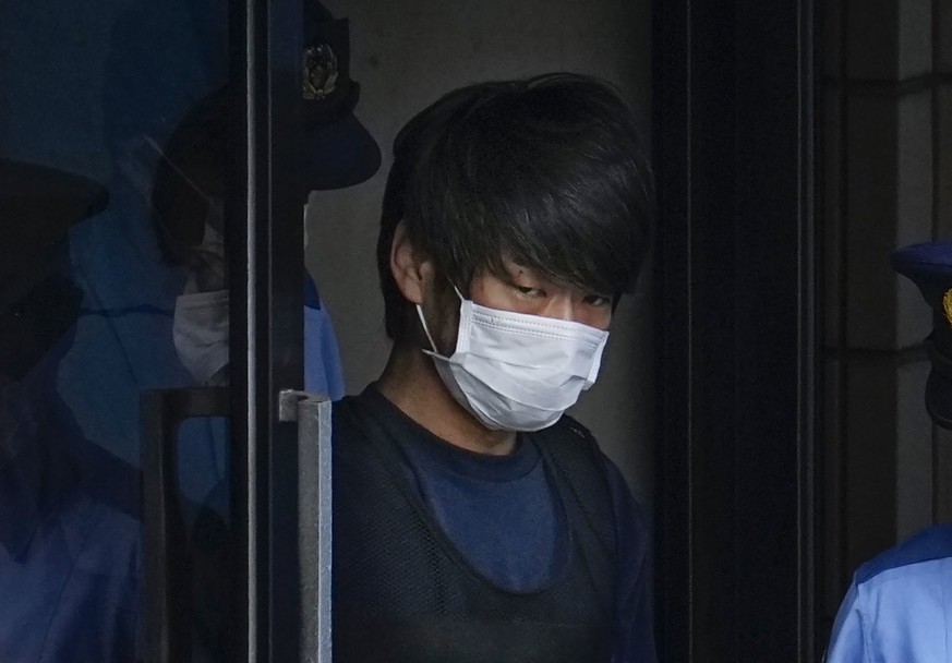 FILE - Tetsuya Yamagami, the alleged assassin of former Japanese Prime Minister Shinzo Abe, gets out of a police station in Nara, western Japan, on July 10, 2022, on his way to local prosecutors&#039; ...