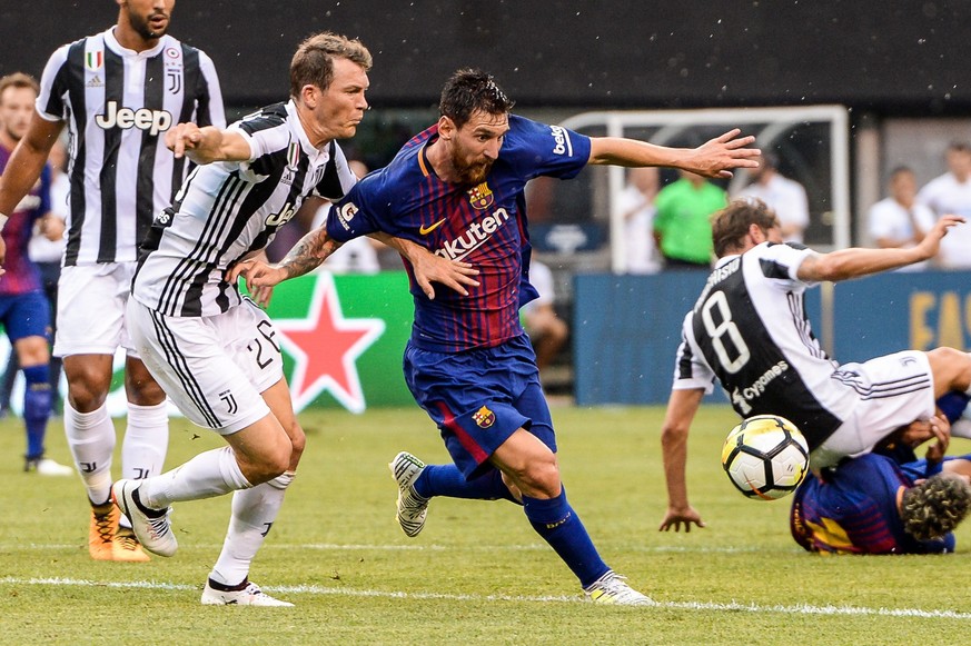EAST RUTHERFORD, NJ - JULY 22: Juventus defender Stephan Lichtsteiner (26) attempts to defend Barcelona midfielder Lionel Messi (10) during the International Champions Cup between Barcelona and Juvent ...