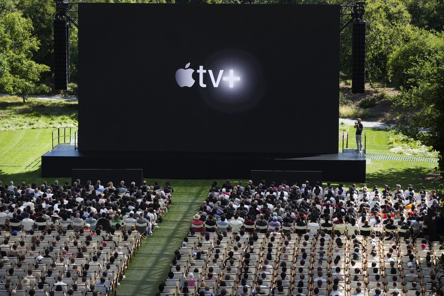 Attendees watch a presentation during an announcement of new Apple products on the Apple campus in Cupertino, Calif., Monday, June 10, 2024. (AP Photo/Jeff Chiu)