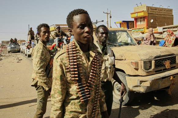 FILE - Soldiers arrive to the Allafah market, in an area recently recaptured by Sudan's army from the Rapid Support Forces paramilitary group, in the Al Kalalah district, south of Khartoum, Sudan ...