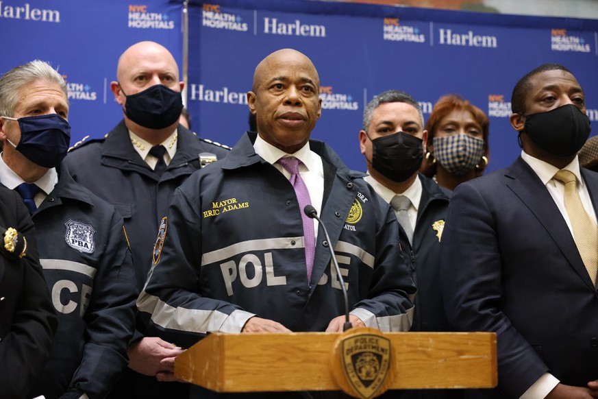 epa09701209 New York City Mayor Eric Adams (C) speaks during a press conference held near the scene where one officer was shot and killed and another critically injured while responding to a domestic  ...