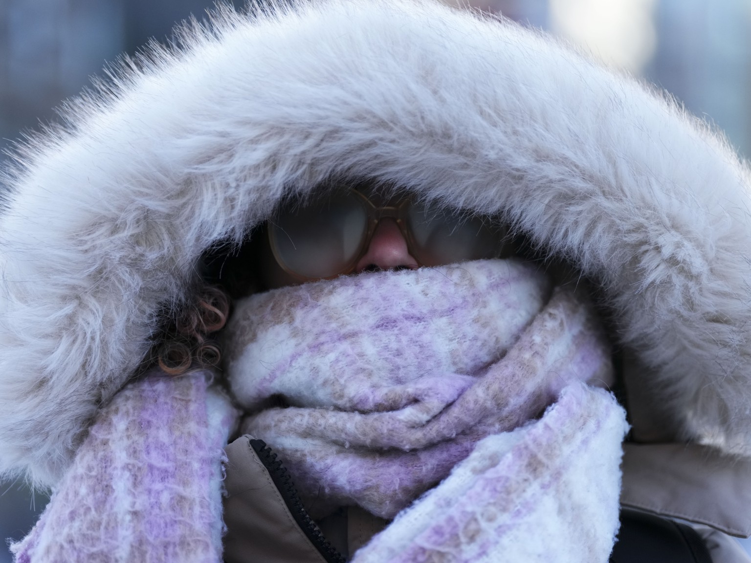 A person makes their way through frigid temperatures in downtown Ottawa, Ontario, Friday, Feb. 3, 2023. Most of Ontario is under an extreme cold warning as a blast of arctic air delivers biting wind c ...
