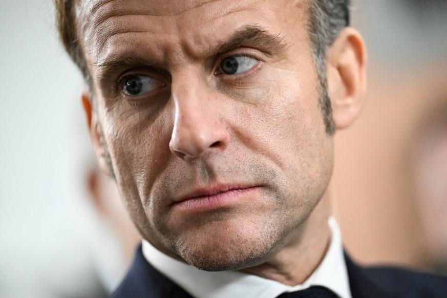 epa12596605 France's President Emmanuel Macron reacts as he attends the inauguration of the new extension of the Baumettes 3 penitentiary centre as part of his visit to Marseille, France, 16 Dece ...