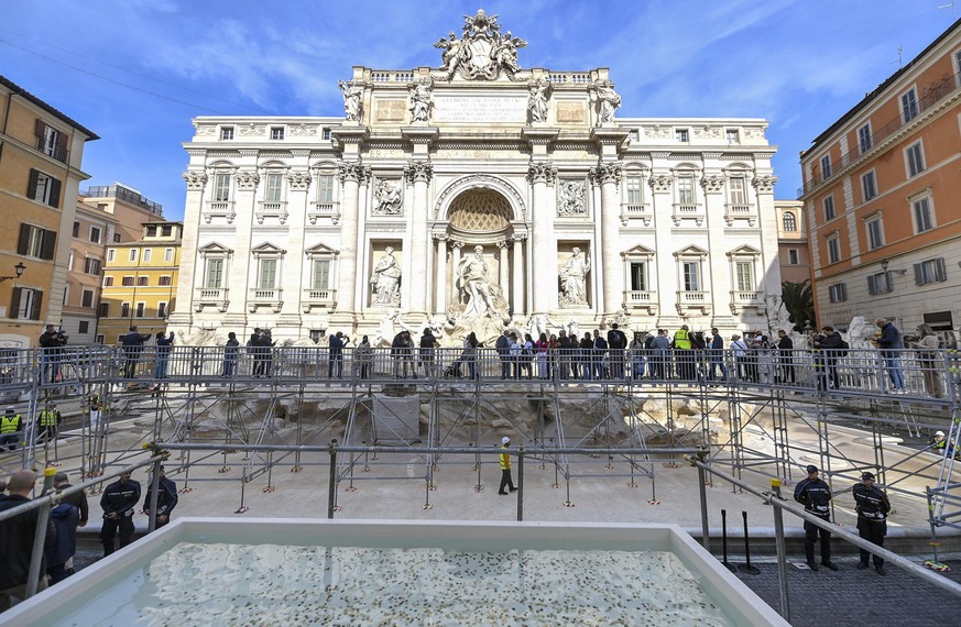 epaselect epa11711287 Tourists cross the walkway to visit the Trevi Fountain during maintenance work, in Rome, Italy, 09 November 2024. The new walkway will allow tourists to visit the 18th century fo ...