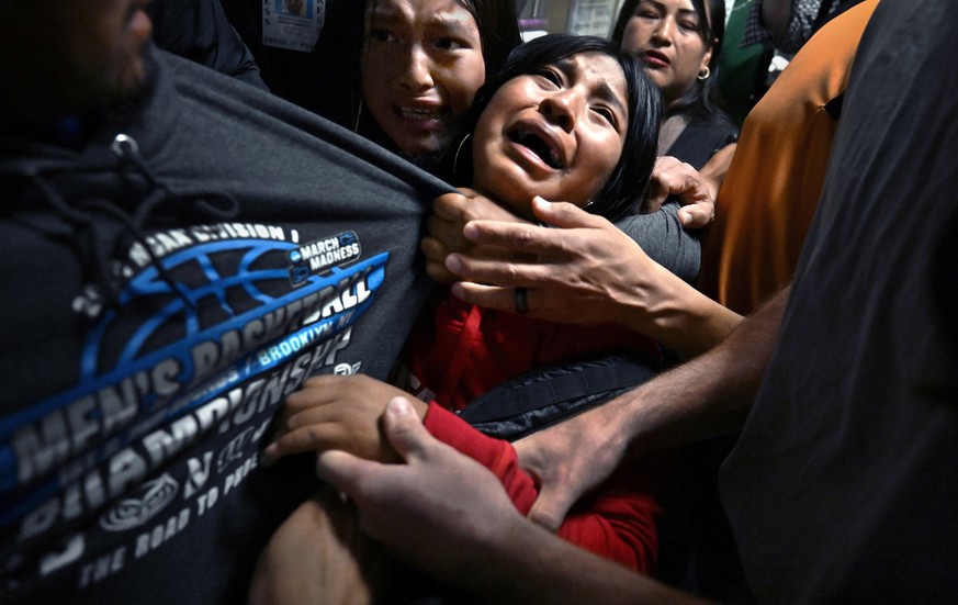epa12908633 A handout photo made available by World Press Photo shows the 2026 World Press Photo of the Year by Carol Guzy, ZUMA Press, iWitness, for Miami Herald depicting distraught girls cling to t ...