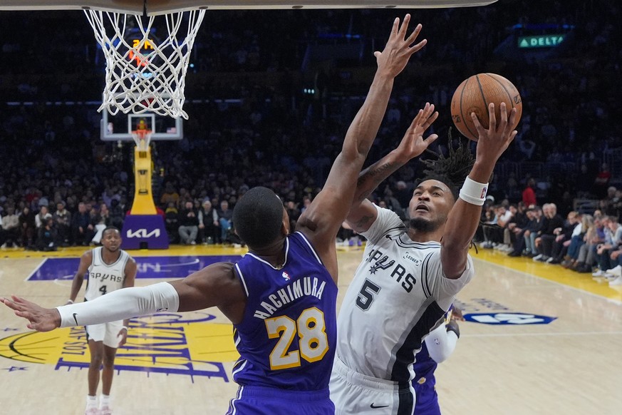 San Antonio Spurs guard Stephon Castle (5) puts up a shot under defense by Los Angeles Lakers forward Rui Hachimura (28) during the second half of an NBA Cup basketball game Wednesday, Dec. 10, 2025,  ...