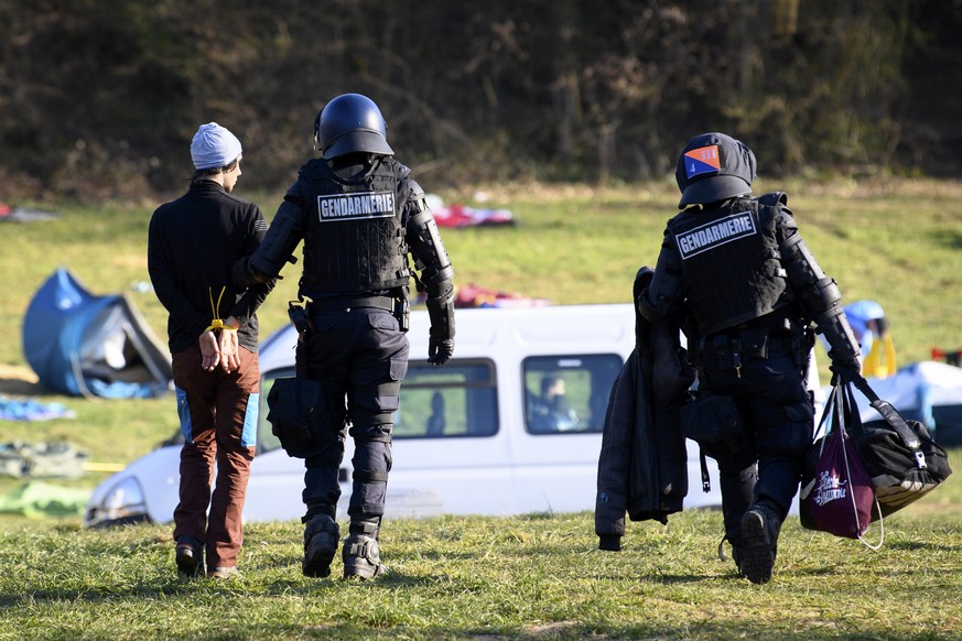 Swiss police officers arrest a climate activist during the operation of the eviction of environmental protesters from the ZAD de la Colline &quot;Zone A Defendre&quot; (zone to defend) installed by en ...