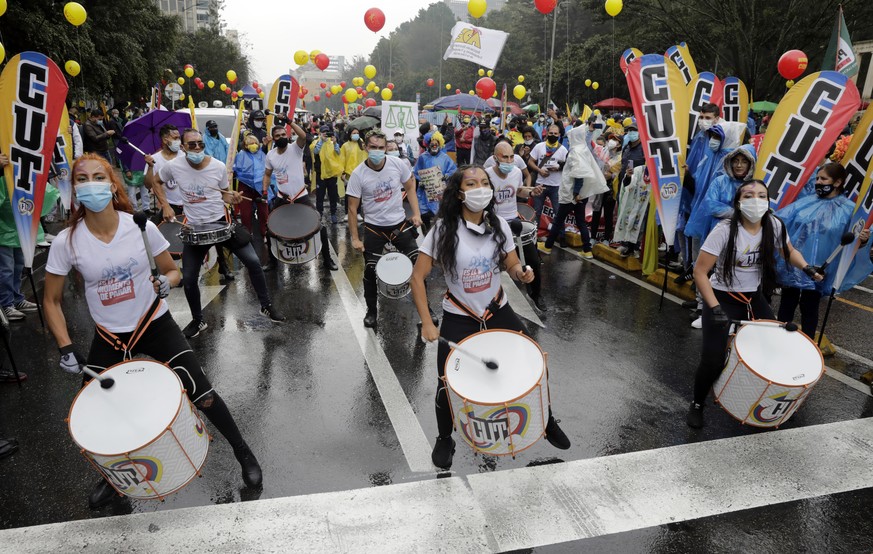 epa09258565 Demonstrators march in the rain in Bogota, Colombia, 09 June 2021. The National Unemployment Committee in Colombia, made up mainly of unions, called a new day of mobilizations on 09 June,  ...