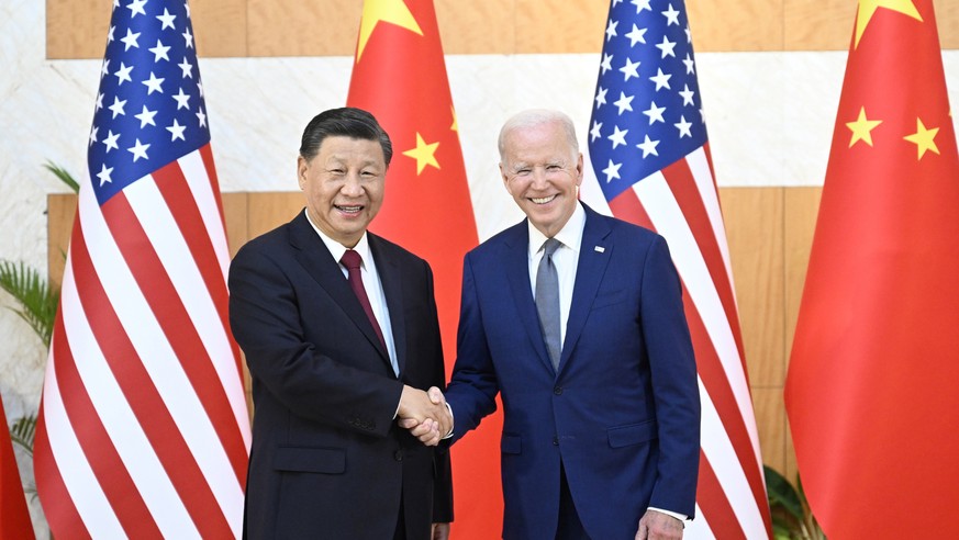 epa10305493 Chinese President Xi Jinping (L) greets his US counterpart Joe Biden before their meeting, one day ahead of the G20 Summit in Bali, Indonesia, 14 November 2022. The 17th Group of Twenty (G ...