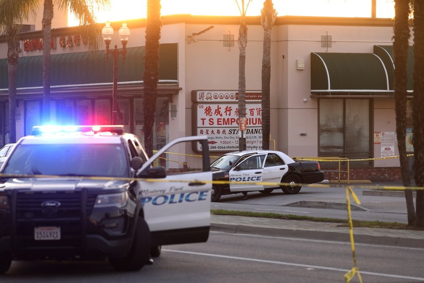 epa10423110 Monterey Park Police vehicles after a mass shooting at a dance studio in Monterey Park, California, USA, 22 January 2023. The shooting killed ten and wounded ten more during a Lunar New Ye ...