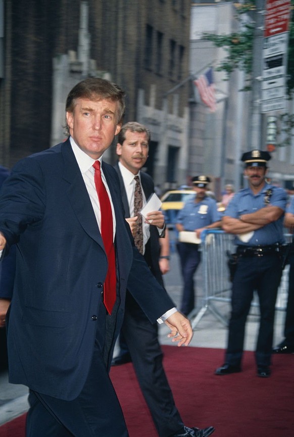 Donald J. Trump blasting a forehand winner from the baseline-with a red, white and blue flag directly over his head. (Photo by Art SEITZ/Gamma-Rapho via Getty Images)