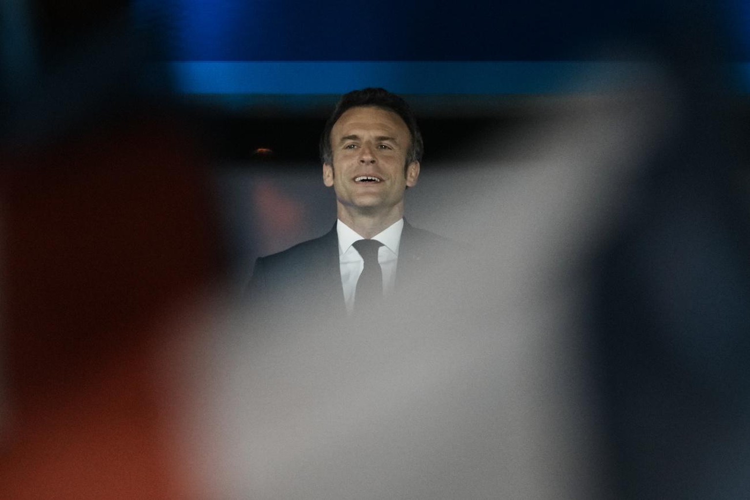 French President Emmanuel Macron celebrates with cheering supporters in Paris, France, Sunday, April 24, 2022. Polling agencies projected that French President Emmanuel Macron comfortably won reelecti ...