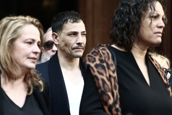 French tv host Steevy Boulay (C) and Loft Story ex-competitor Julie Mercy (R) leave after attending the funeral ceremony of Loana Petrucciani, the first reality TV star in France, at the cathedral of  ...
