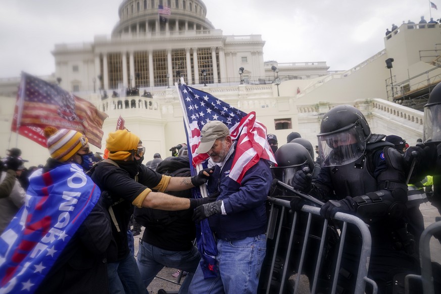 FILE - Rioters try to break through a police barrier at the Capitol on Jan. 6, 2021, in Washington. Some of the best sources for &quot;Day of Rage,&quot; a painstaking 40-minute video investigation in ...