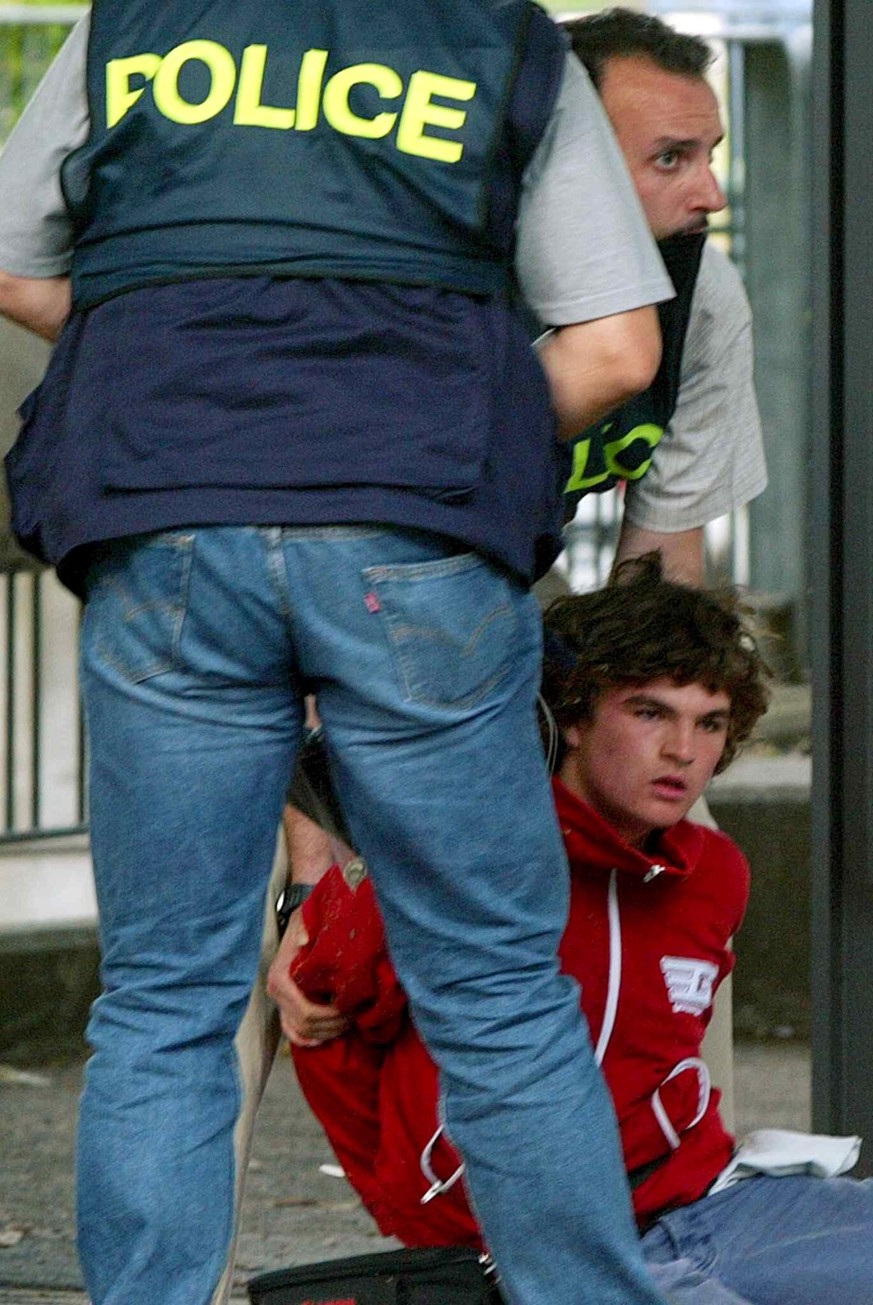 A protester is arrested during clashes between anti-gloablisation demonstrators and riot police in Geneva, Switzerland, Tuesday, June 3, 2003. After the end of the G8 summit in Evian clashes between a ...