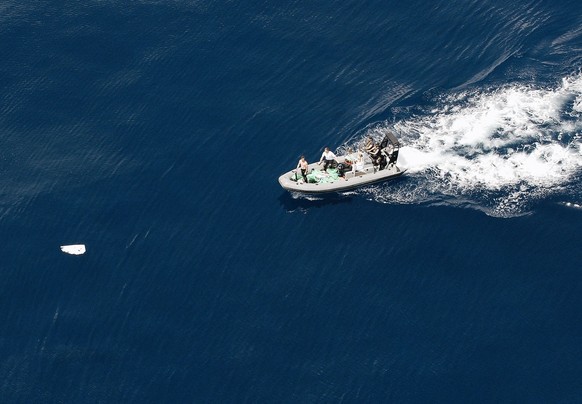 This photo released Wednesday June 17, 2009 by the French army shows soldiers approaching a piece of debris believed to be part of Air France flight 447, during continuing searches for debris and bodi ...