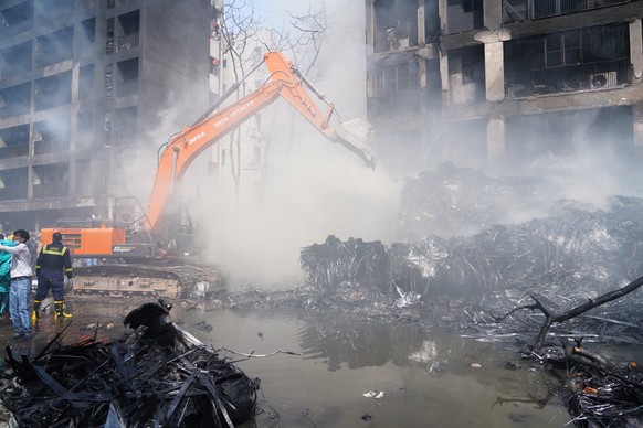 epa12171337 Firefighters work at the site of a plane crash near Sardar Vallabhbhai Patel International Airport in Ahmedabad, Gujarat, western India, 12 June 2025. Air India flight AI171, bound for Lon ...