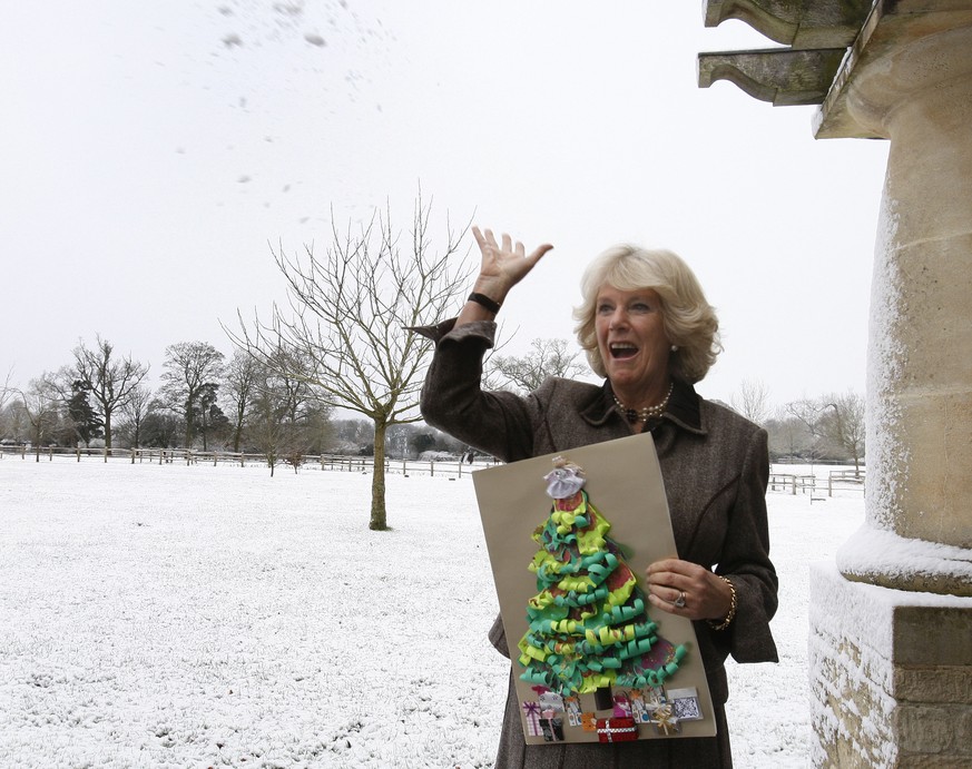FILE - Britain&#039;s Camilla, Duchess of Cornwall throws a snowball after attending a tea party for children from Ty Hafan hospice in Wales, at Highgrove House in Gloucestershire, England, Monday, De ...