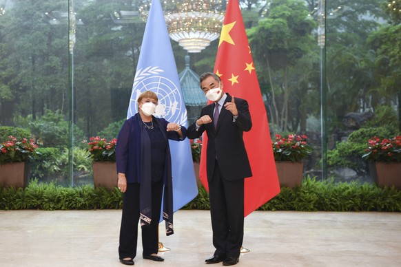 In this photo released by Xinhua News Agency, Chinese Foreign Minister Wang Yi, right, meets with the United Nations High Commissioner for Human Rights Michelle Bachelet in Guangzhou, southern China&# ...