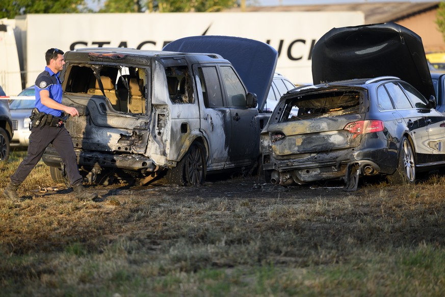 2 cars charred after a fire are pictured in a parking during the first day of the 45th edition of the Paleo Festival, in Nyon, Switzerland, Tuesday, July 19, 2022. The Paleo is the largest open-air mu ...