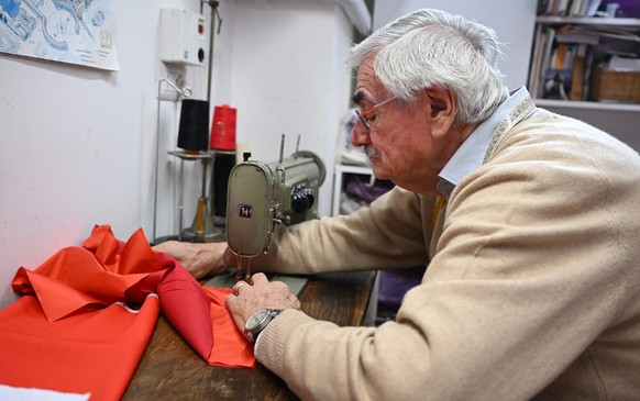 (FILES) Italian ecclesiastical tailor, Raniero Mancinelli, 86, works on a cardinal&#039;s cassock in his shop in Borgo Pio, a neighborhood close to the Vatican, on November 19, 2024. For decades one R ...