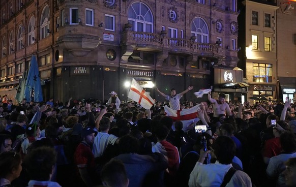 England supporters celebrate in Leicester Square in London, Saturday, July 3, 2021 after going there to celebrate England&#039;s 4-0 win in the Euro 2020 soccer championship quarter final match betwee ...