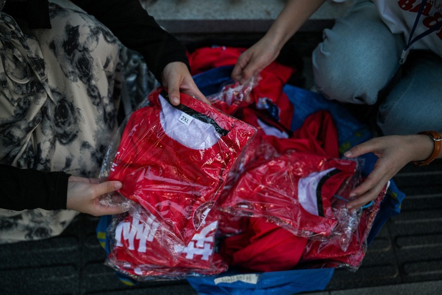 Sellers sell Suzhou amateur football team t-shirts to fans heading to the stadium to watch the amateur league football match between Suzhou and Zhenjiang at the Suzhou Sport Center, in eastern China&# ...