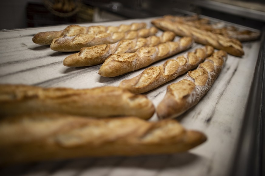 epa09035249 Freshly baked baguettes are layed out in the downstairs kitchen of the &#039;Coudrier Geffroy&#039; bakery owned by Freddy Coudrier, in Paris, France, 24 February 2021 (issued 25 February  ...