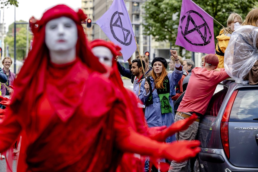 epa09971588 Extinction Rebellion activists demonstrate in front of an office of Shell Netherlands in Rotterdam, the Netherlands, 24 May 2022. The protest by climate activists is aimed at the emissions ...