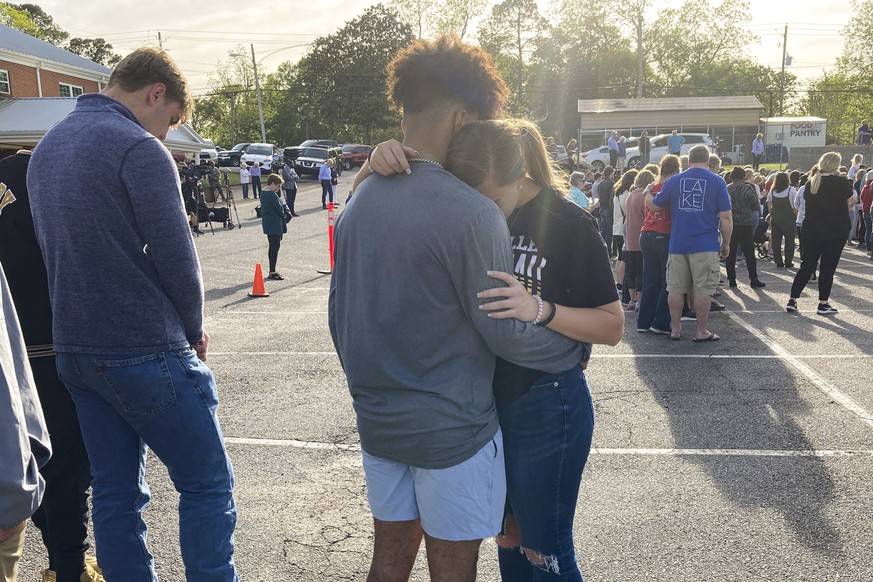 Two teens embrace at a prayer vigil on Sunday, April 16, 2023, outside First Baptist Church in Dadeville, Ala. Several people were killed and over two dozen were injured in a shooting at a teen birthd ...