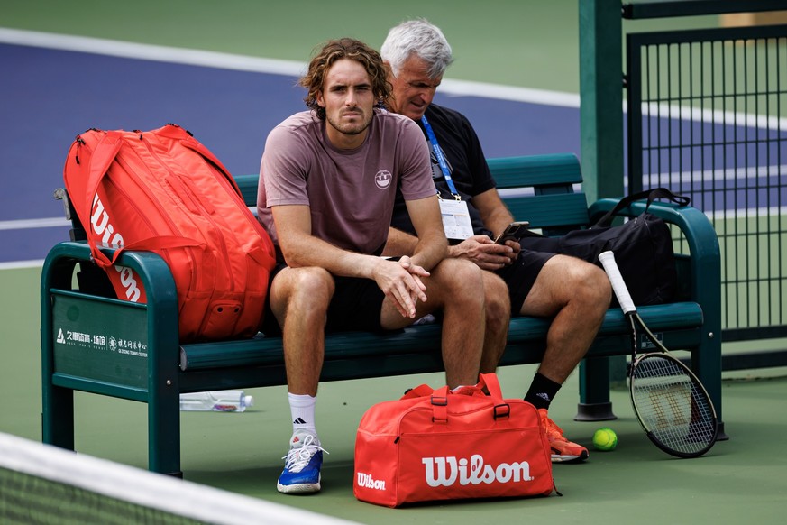 SHANGHAI, CHINA - OCTOBER 02: Stefanos Tsitsipas of Greece cools down after a practice session with his father and coach, Apostolos Tsitsipas on Day 1 of the 2023 Shanghai Rolex Masters at Qi Zhong Te ...