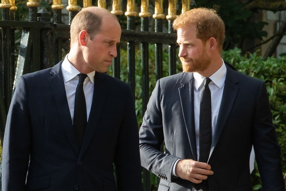 Prince William, the new Prince of Wales, and Prince Harry, the Duke of Sussex, arrive to view floral tributes to Queen Elizabeth II laid outside Cambridge Gate at Windsor Castle on 10th September 2022 ...
