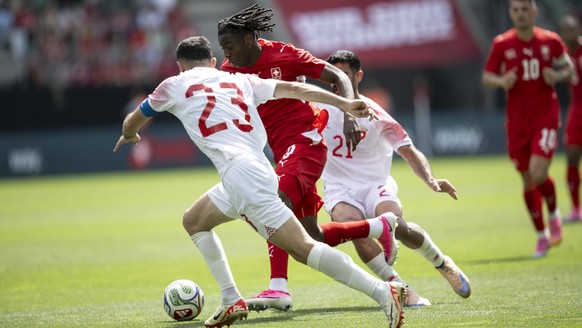 Jordan's Ehsan Haddad, left, and Switzerland's Johan Manzambi in action during the friendly soccer match between Switzerland and Jordan, at the kybunpark, in St. Gallen, Switzerland, Sunday, ...