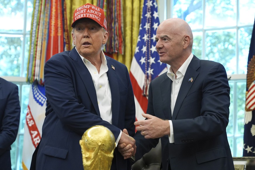 President Donald Trump, left, shakes the hand of FIFA President Gianni Infantino at the conclusion of an announcement in the Oval Office of the White House, Friday, Aug. 22, 2025, in Washington. (AP P ...