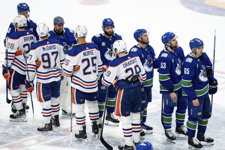 Vancouver Canucks and Edmonton Oilers players shake hands after Game 7 of an NHL hockey Stanley Cup second-round playoff series, in Vancouver, British Columbia, on Monday, May 20, 2024. (Ethan Cairns/ ...