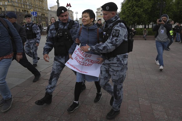Police officers detain a demonstrator with a poster that reads: &quot;Happy Birthday Alexei (Navalny)&quot;, in Pushkinskaya Square in Moscow, Russia, Sunday, June 4, 2023. Imprisoned opposition leade ...