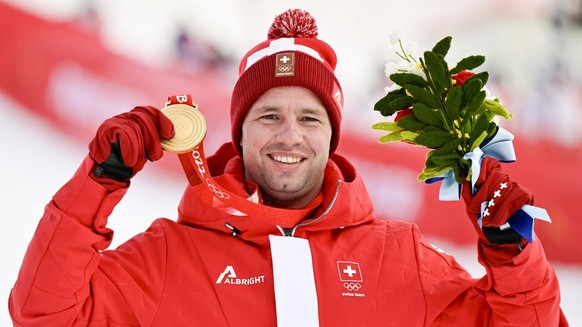 Gold medalist Beat Feuz of Switzerland celebrates during the victory ceremony of the men&#039;s Alpine Skiing downhill race at the 2022 Olympic Winter Games in Yanqing, China, on Monday, February 7, 2 ...