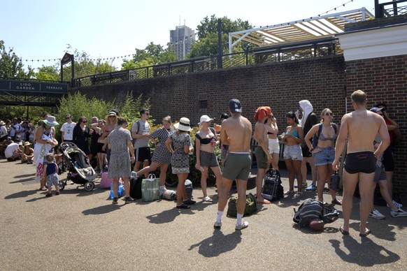 People queue to enter the swimming lido in The Serpentine Lake in Hyde Park in London, Tuesday, July 19, 2022. Britain shattered its record for highest temperature ever registered amid a heat wave tha ...