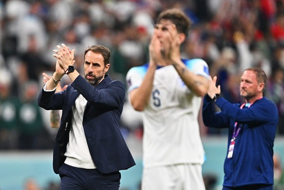 epa10328883 England manager Gareth Southgate (L) and team members applaud fans after the FIFA World Cup 2022 group B soccer match between England and the USA at Al Bayt Stadium in Al Khor, Qatar, 25 N ...