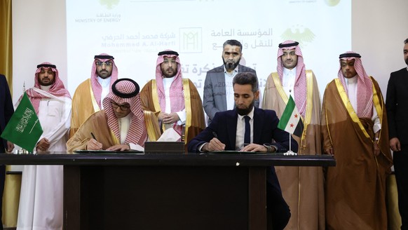 DAMASCUS, SYRIA - OCTOBER 01: Syrian Deputy Energy Minister Omar Shakrouk, Syrian Electricity Director General Khalid Abu Dey (R), representatives of Saudi Arabian companies Hirefi and SCLCO and the T ...