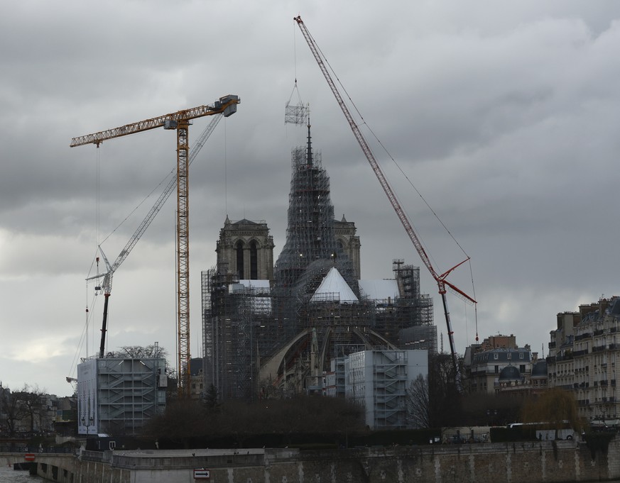 Scaffolding is being removed around the spire of Notre Dame de Paris cathedral, Monday, Feb. 12, 2024 in Paris. Notre Dame cathedral is expected to reopen in Dec. 2024. (AP Photo/Aurelien Morissard)