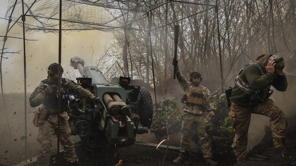 Ukrainian soldiers fire howitzer D-30 at the frontline near Bakhmut, Donetsk region, Ukraine, Wednesday, Apr. 19, 2023. (Roman Chop via AP)